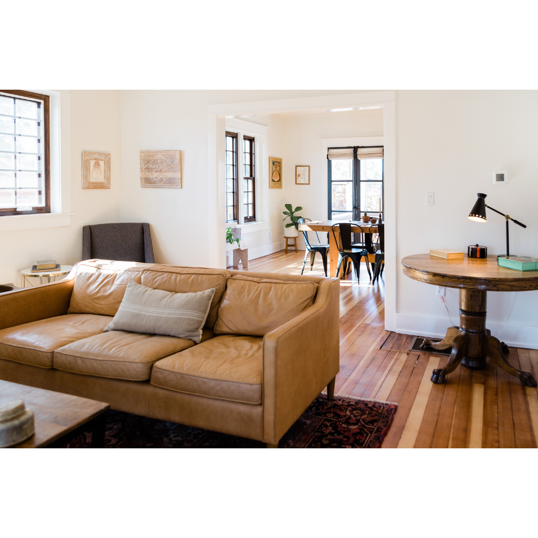 Cozy living room with hardwood floors, white walls, minimalist decor