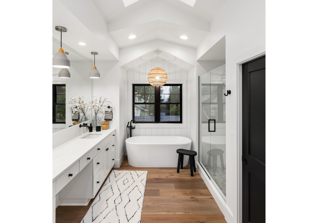 Gorgeous modern farmhouse bathroom with walk in shower, tub, marble countertops and hardwood floor